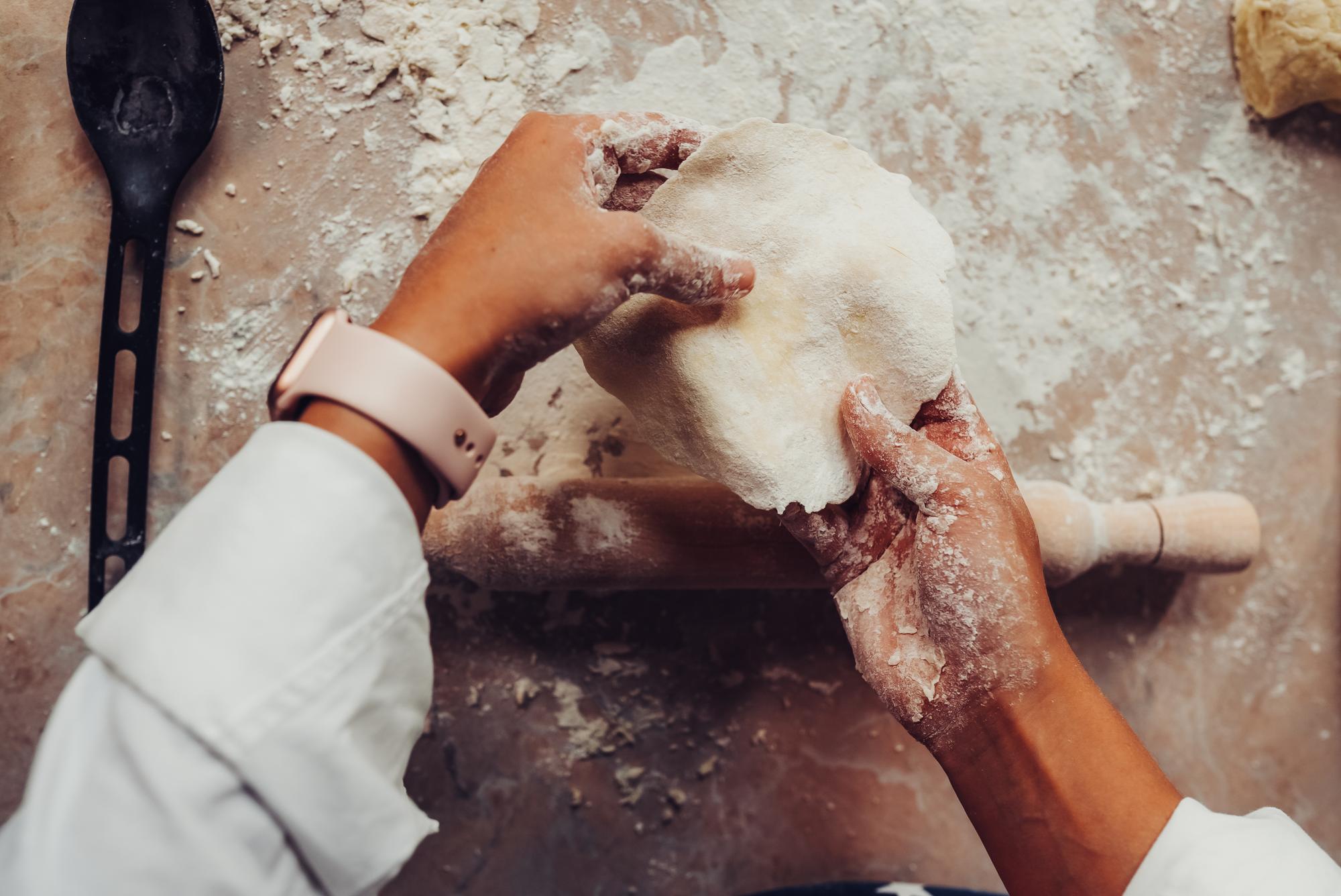 Close-up of hands kneading artisanal dough